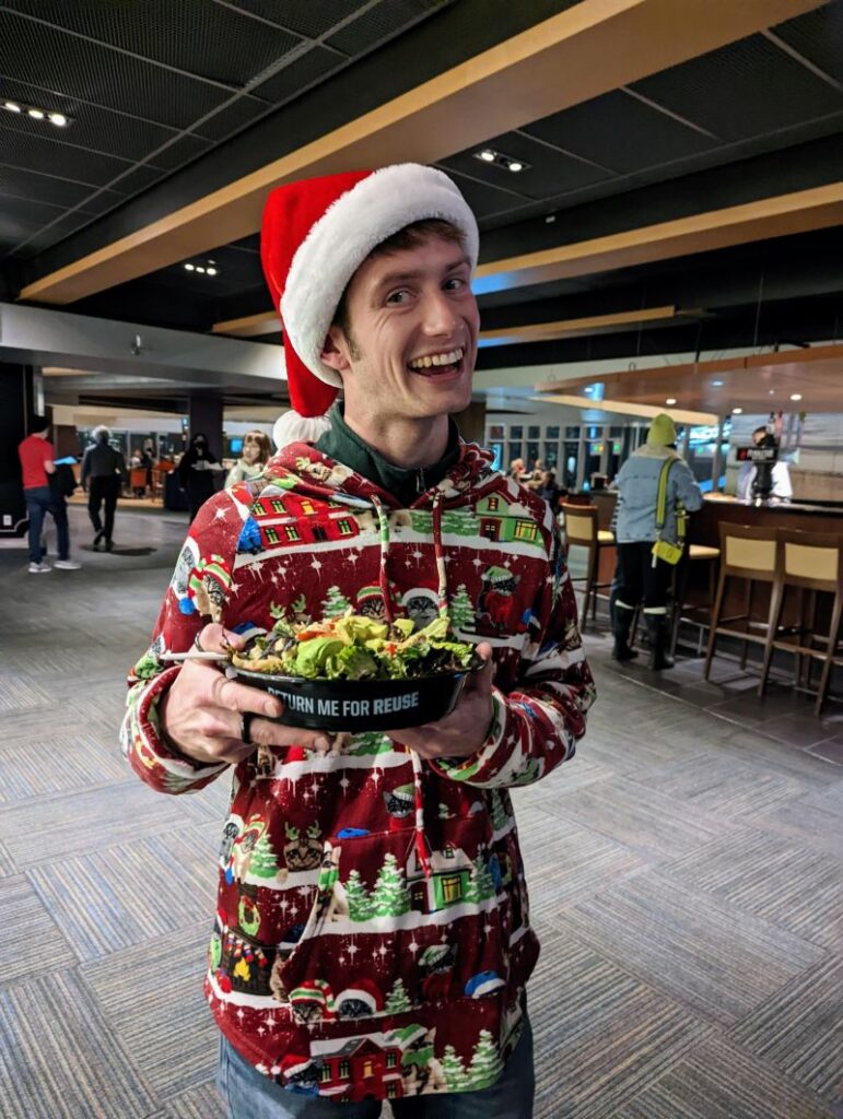 Customer at a Portland Trail Blazers game enjoying food in a reusable container!